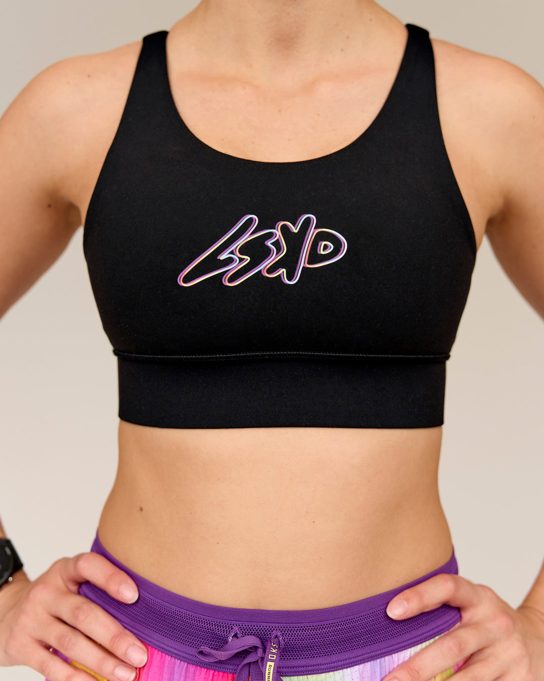 Woman wearing Accelerate Graphic Sports Bra - Black-Radiate - view 1