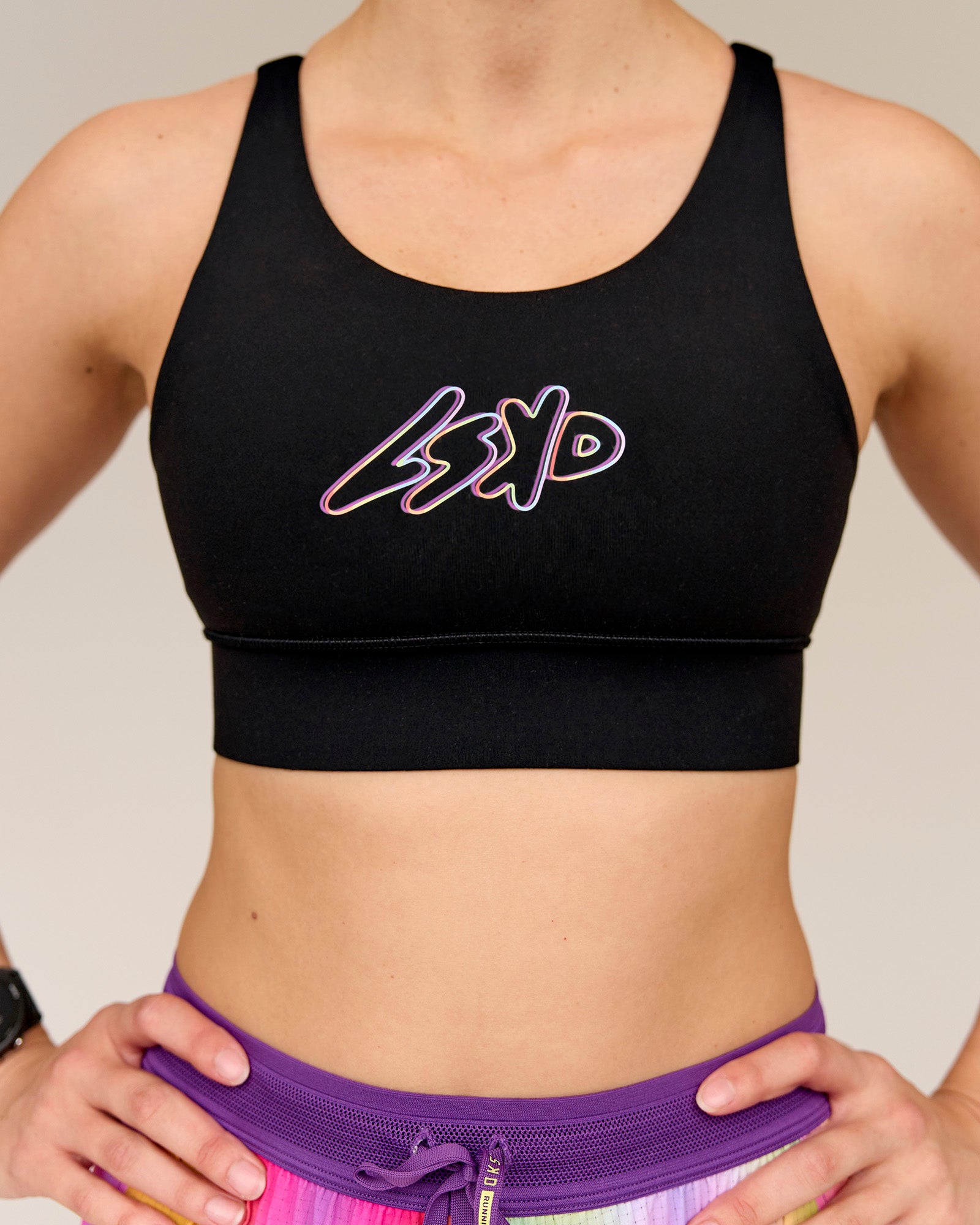 Woman wearing Accelerate Graphic Sports Bra - Black-Radiate
