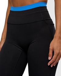 Woman wearing Liberate High-Rise Full Length Legging Pockets - Black-Palace Blue | Model:Brylee | Size:XS | Thumbnail Index: 1