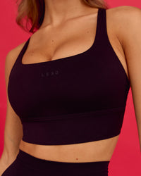 Woman wearing Twist Long Line Sports Bra in Black  | Thumbnail Index: 0