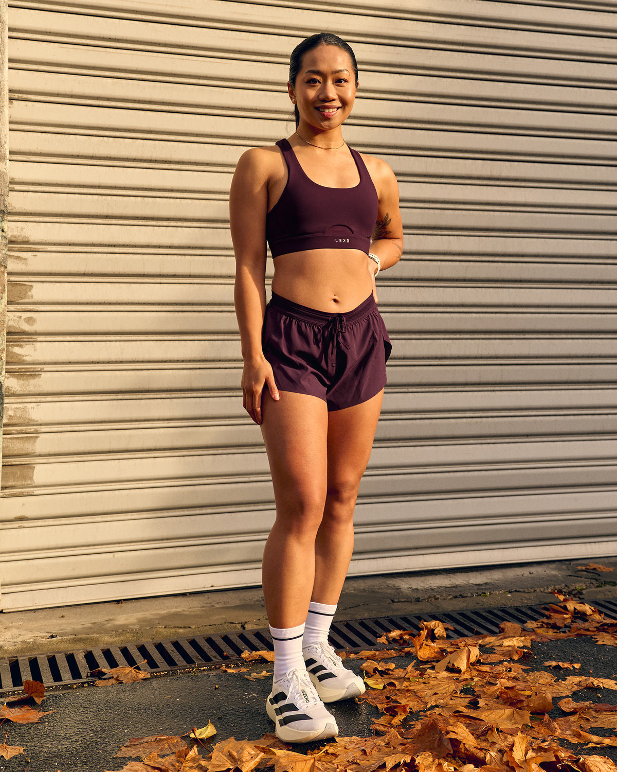 Woman wearing Accelerate 3" Mid-Rise Running Short - Cherry Lacquer
