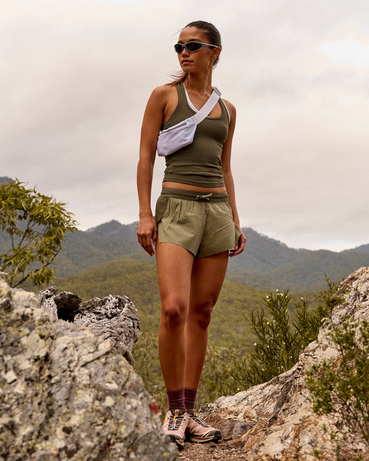 Woman wearing Accelerate 3" Mid-Rise Running Short - Pure Olive-Fog