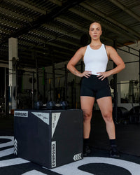 Woman wearing Flow Performance Tank - White | Thumbnail Index: 3