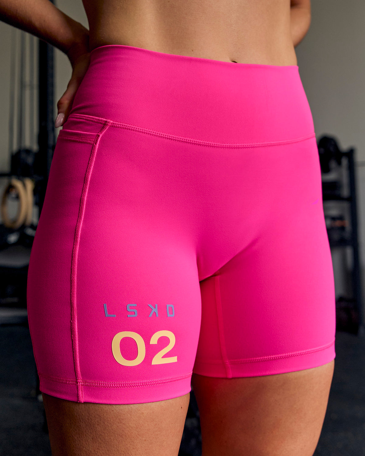 Woman wearing Fusion V-Contour High-Rise 6" Short Pockets - Ultra Pink-Tech Department