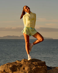 Woman wearing GG AeroFLX+ Long Sleeve Half Zip - Lemon-Baltic Sea | Model:Grace | Size:XS | Thumbnail Index: 13