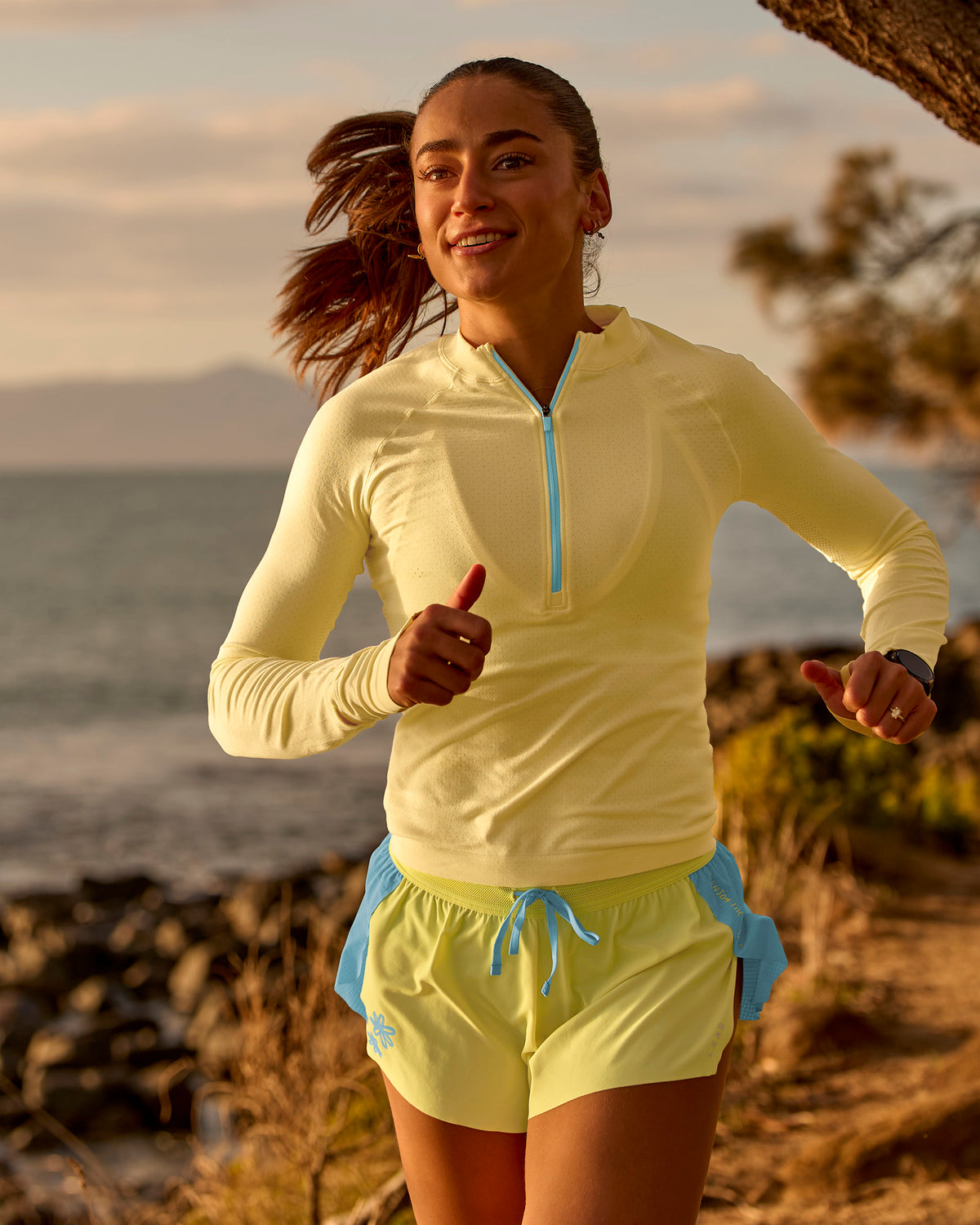 Woman wearing GG AeroFLX+ Long Sleeve Half Zip - Lemon-Baltic Sea | Model:Grace | Size:XS