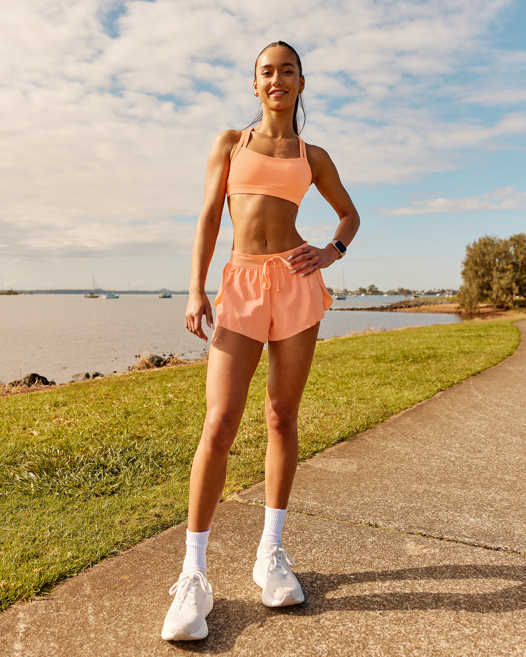Woman wearing Velocity Sports Bra - Cantaloupe | Model:Zara | Size:2XS - view 3