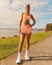Woman wearing Velocity Sports Bra - Cantaloupe | Model:Zara | Size:2XS | Thumbnail Index: 2