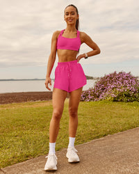 Woman wearing Velocity Sports Bra - Ultra Pink | Model:Zara | Size:2XS | Thumbnail Index: 12