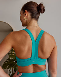 Woman wearing Advance Sports Bra - Uplift Blue | Thumbnail Index: 0