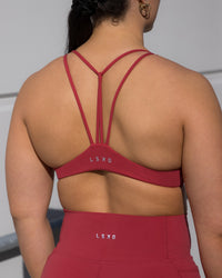 Woman wearing Agile Sports Bra - Claret | Thumbnail Index: 1