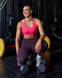 Woman wearing Aspire Sports Bra - Pink Flash | Thumbnail Index: 1