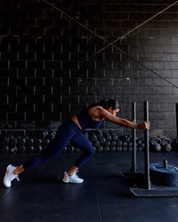 Woman wearing Elite High-Rise 7/8 Legging Pockets - Midnight Blue | Thumbnail Index: 1