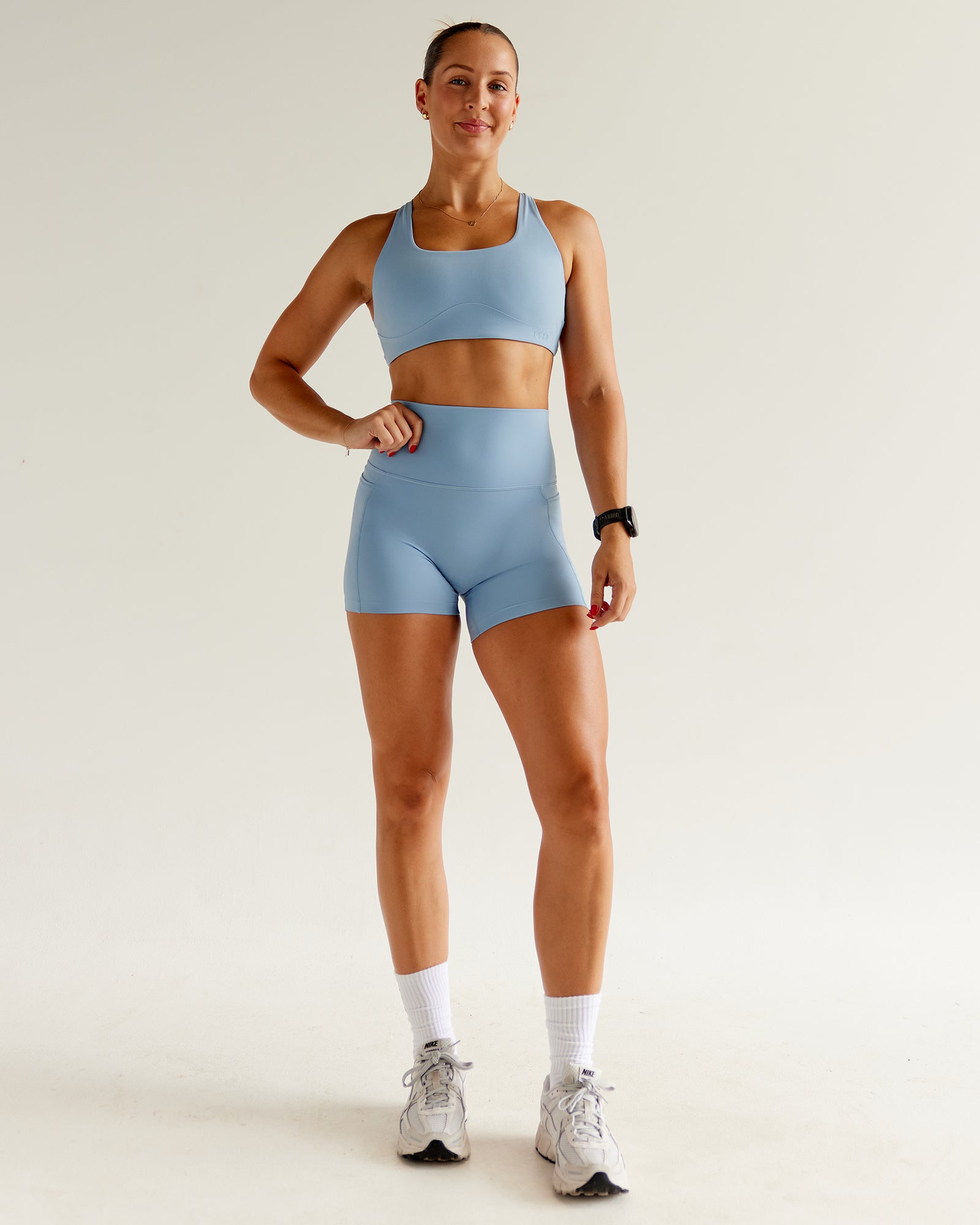 Woman wearing Elixir Ultra High-Rise 4" Short Pockets - Glacier Lake | Model:Abbey | Size:S