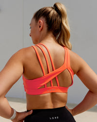 Woman wearing Galvanise Sports Bra - Ultra Orange | Thumbnail Index: 1