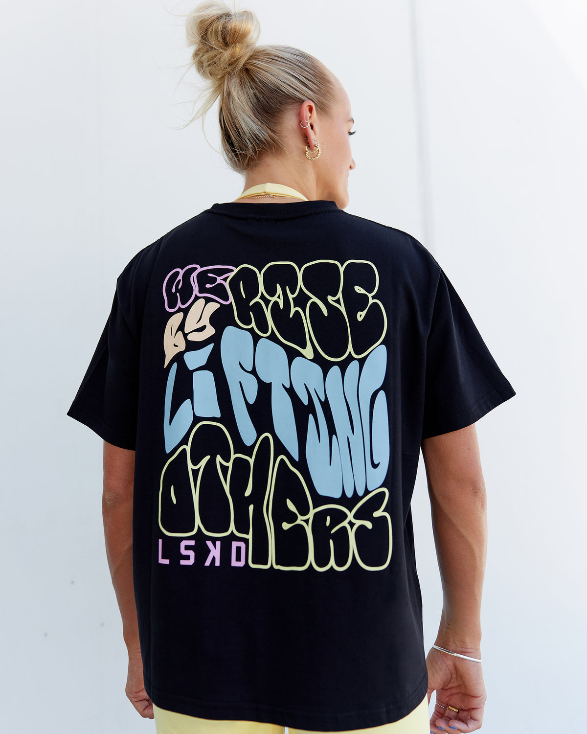 Woman wearing Go-To We Rise FLXCotton Oversized Tee - Black-Glacial Blue