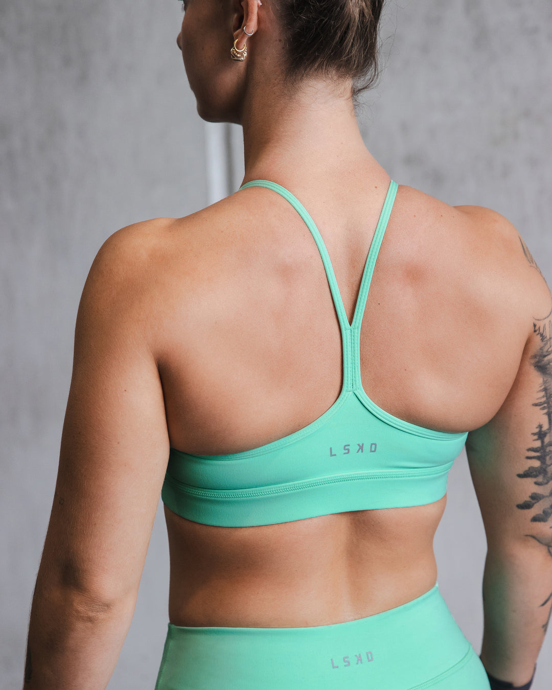 Woman wearing Lift High Neck Sports Bra - Cockatoo - view 6