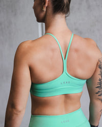 Woman wearing Lift High Neck Sports Bra - Cockatoo | Thumbnail Index: 5