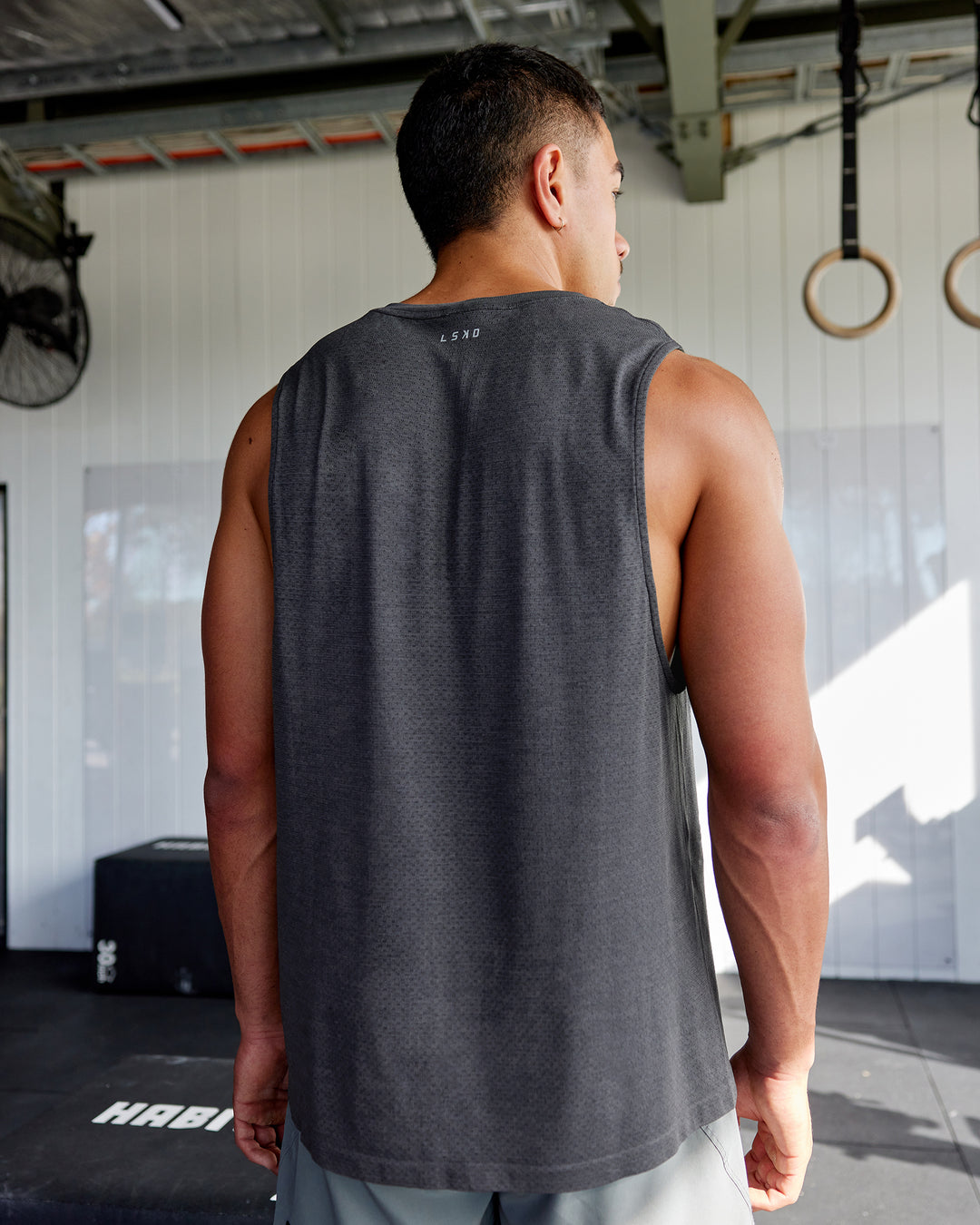 Man wearing AeroFLX+ Seamless Muscle Tank - Pirate Black Marl - view 2