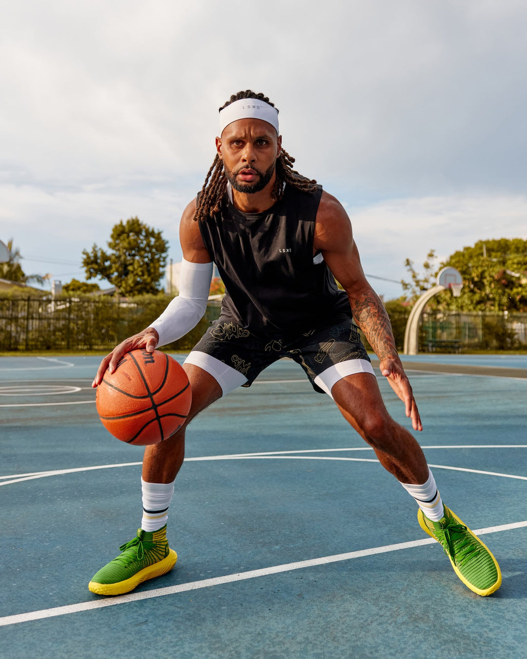 Man wearing Patty Mills Challenger 6" Performance Shorts - Black-Vital Green - view 3