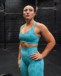 Woman wearing Push The Limit Sports Bra - Aquatic Awe Vitality Print | Thumbnail Index: 1