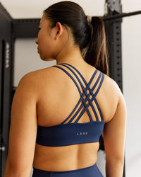 Woman wearing Push The Limit Sports Bra - Future Navy | Thumbnail Index: 0