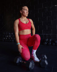 Woman wearing Push The Limit Sports Bra - Red Vitality Print | Thumbnail Index: 0