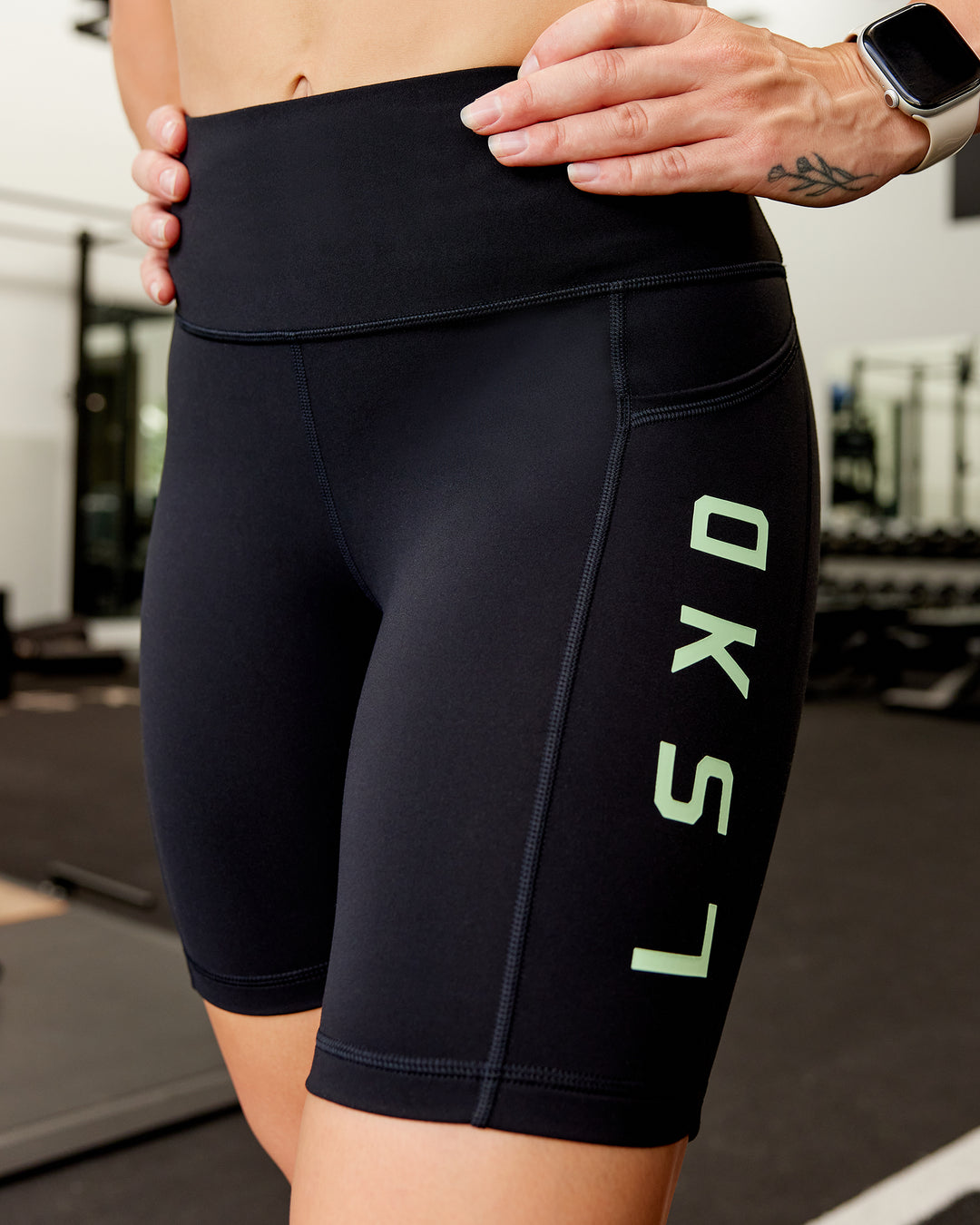 Woman wearing Rep Ultra High-Rise 9" Short Pockets - Black-Surreal Green | Model:Amber | Size:S - view 2