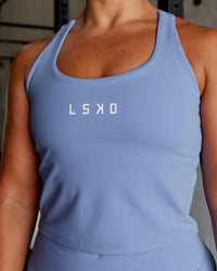 Woman wearing Rep Shelf Bra Performance Tank - Arctic Blue | Thumbnail Index: 0