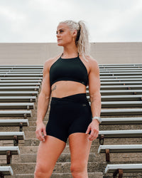 Woman wearing Sara Ares High Neck Sports Bra - Black | Thumbnail Index: 0