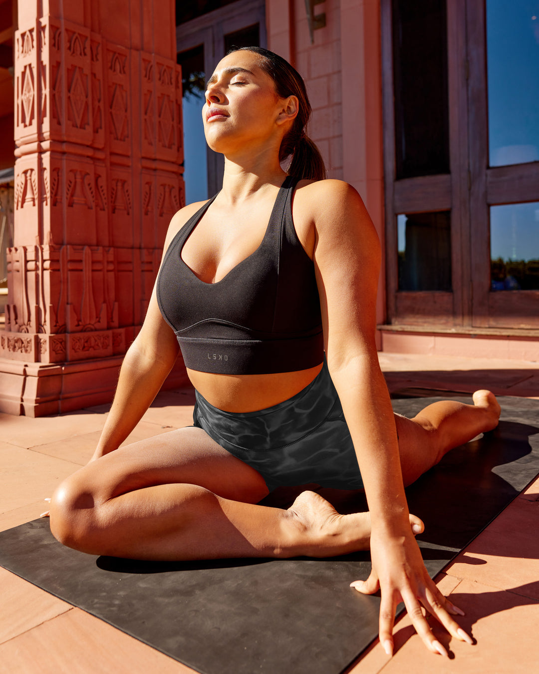 Woman wearing Sculpt Sports Bra - Black - view 1