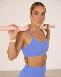 Woman wearing Twist Sports Bra - Indulgent Blue | Thumbnail Index: 4