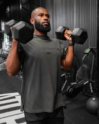 Man wearing Unisex 1% Better FLXCotton Tee Oversize - Pirate Black-Black | Thumbnail Index: 1