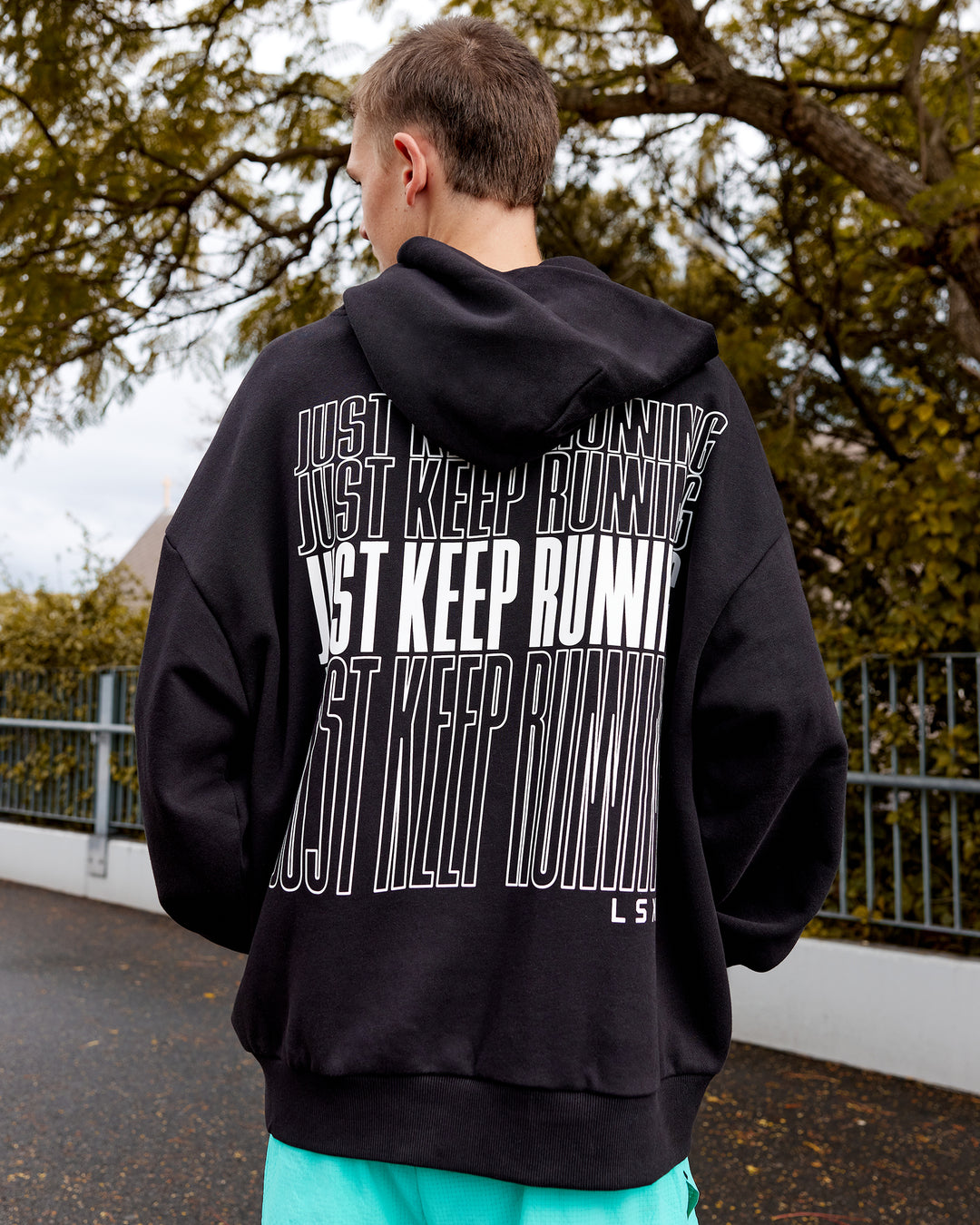 Man wearing Unisex Keep on Running Hoodie Oversize - Black-White - view 2