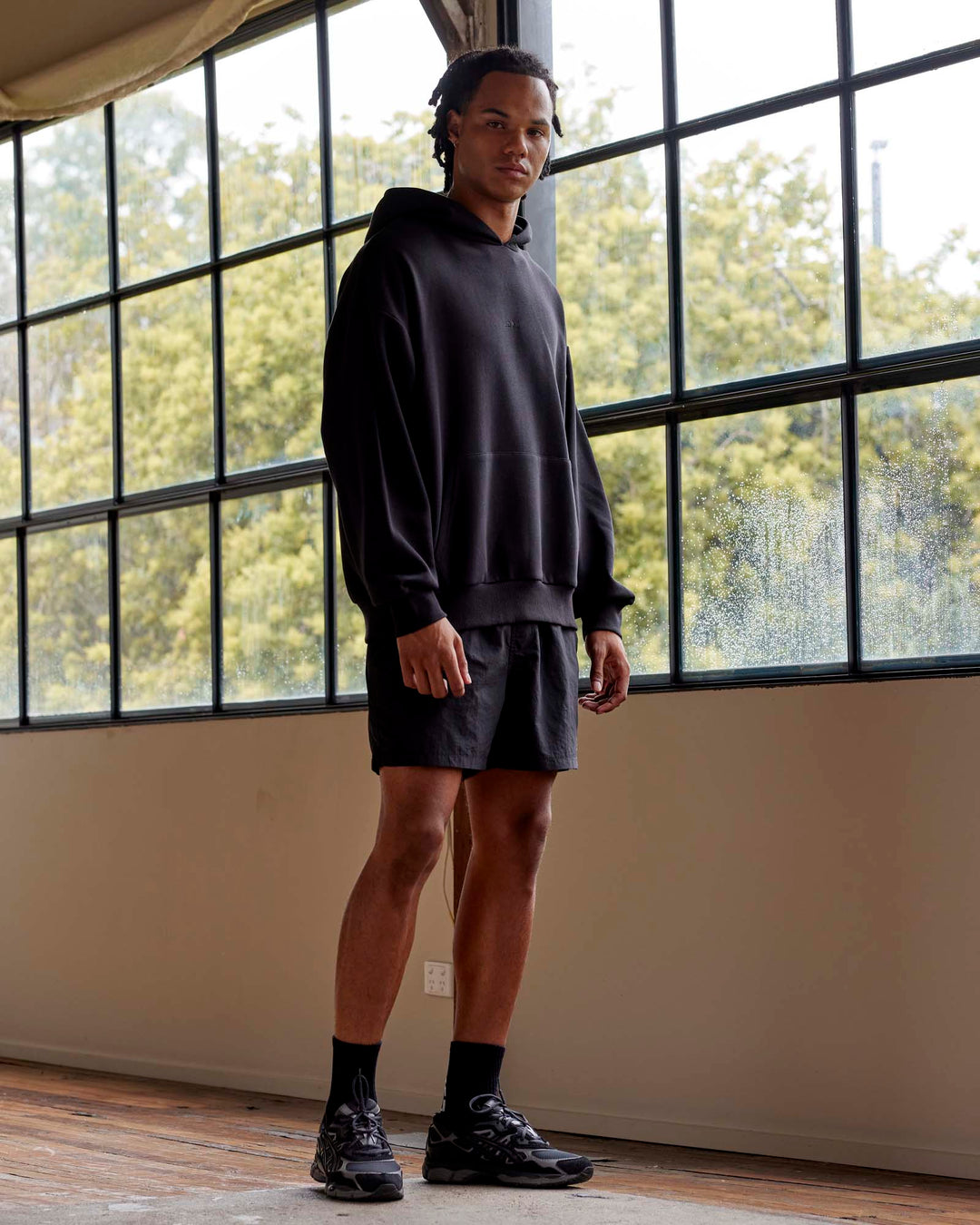 Man wearing Unisex MVP Hoodie Oversize - Black - view 3