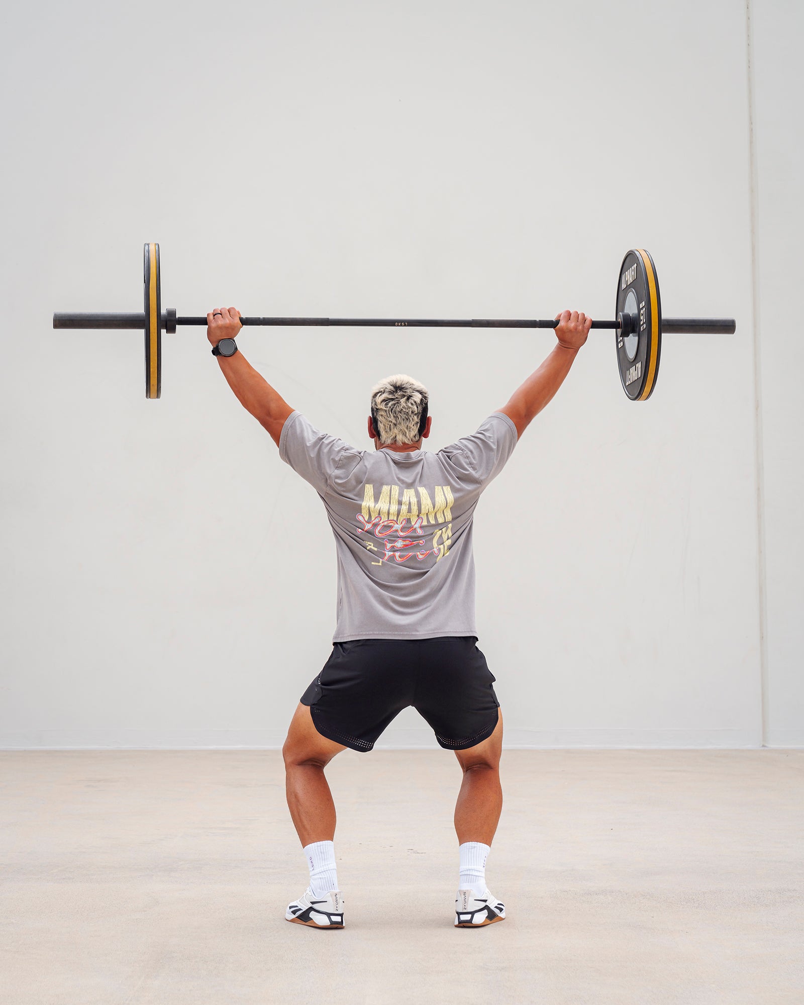 Man wearing Unisex Miami25 Washed FLXCotton Tee Oversize - Storm Front-Lemon Fizz
