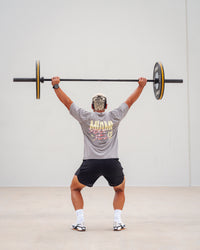 Man wearing Unisex Miami25 Washed FLXCotton Tee Oversize - Storm Front-Lemon Fizz | Thumbnail Index: 1