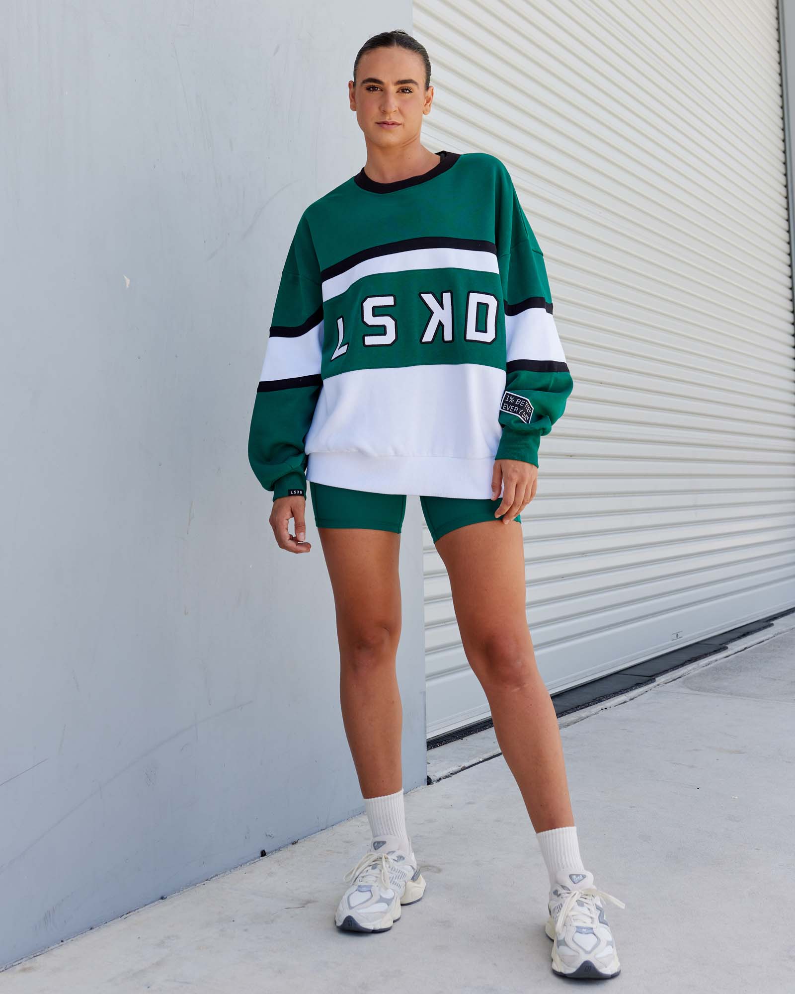 Woman wearing Unisex PrimeTime Sweater Oversize - Malachite-White