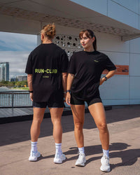 Duo wearing Unisex RUN CLUB FLXCotton Tee Oversize - Black-Volt | Thumbnail Index: 0
