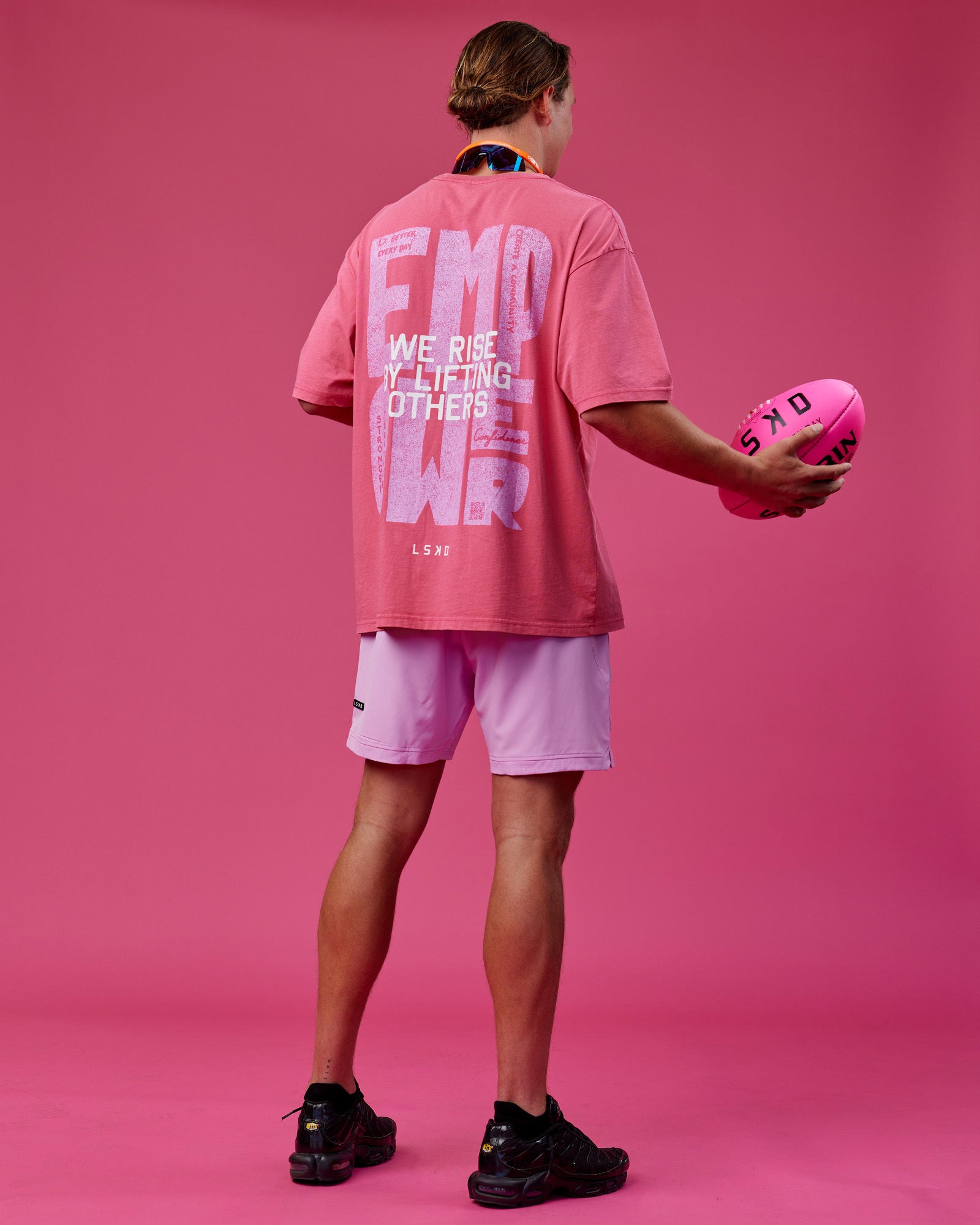 Man wearing Unisex Washed Empower Tee Oversize - Berry Pink-Pastel Orchid