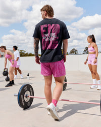 Man wearing Unisex Washed Empower Tee Oversize - Black-Berry Pink | Thumbnail Index: 0