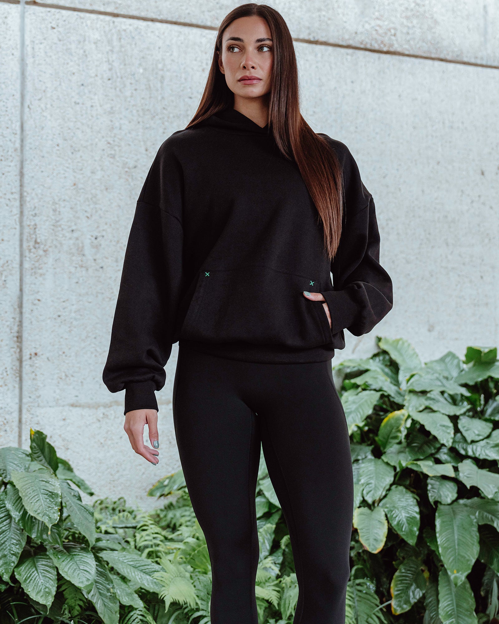 Woman wearing Unisex We Rise Hoodie Oversize - Black-Impact Green