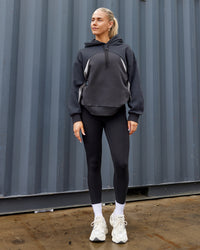 Woman wearing Unisex Y2K Concept Panel Hoodie - Asphalt-Turbulance | Thumbnail Index: 1