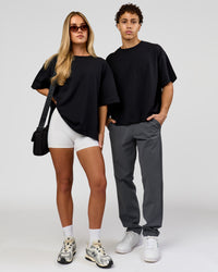 Duo wearing AfterDark ZeroCrease Boxy Tee in Black | Model:Issy | Size:XS | Model:Leandro | Size:M | Thumbnail Index: 2