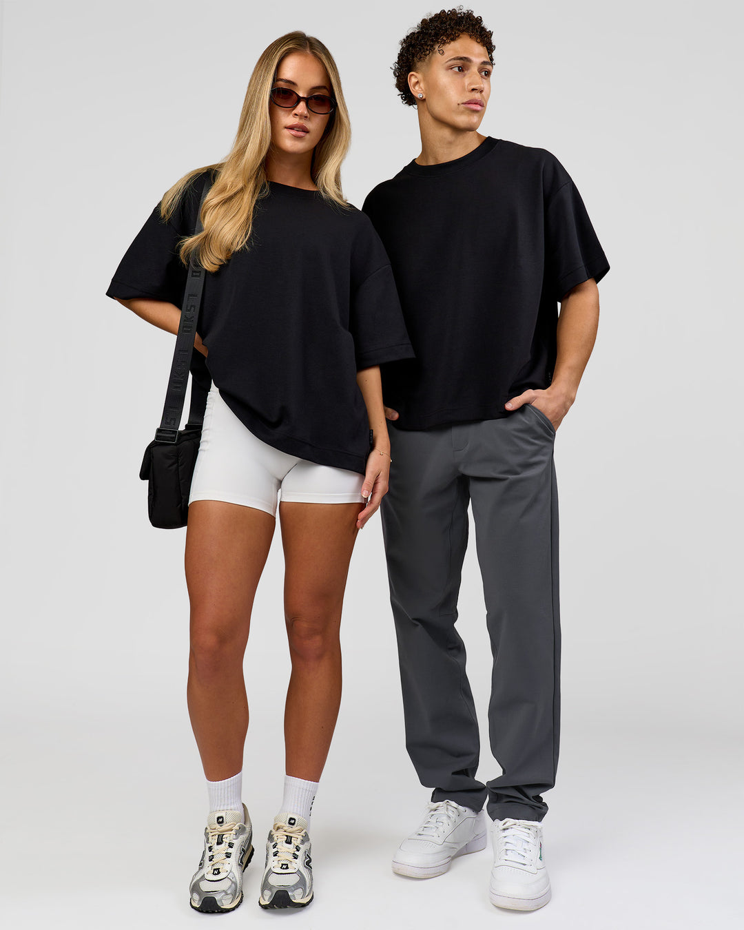 Duo wearing AfterDark ZeroCrease Boxy Tee in Black | Model:Issy | Size:XS | Model:Leandro | Size:M - view 4