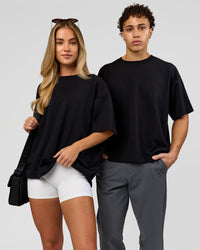 Duo wearing AfterDark ZeroCrease Boxy Tee in Black | Model:Issy | Size:XS | Model:Leandro | Size:M | Thumbnail Index: 4