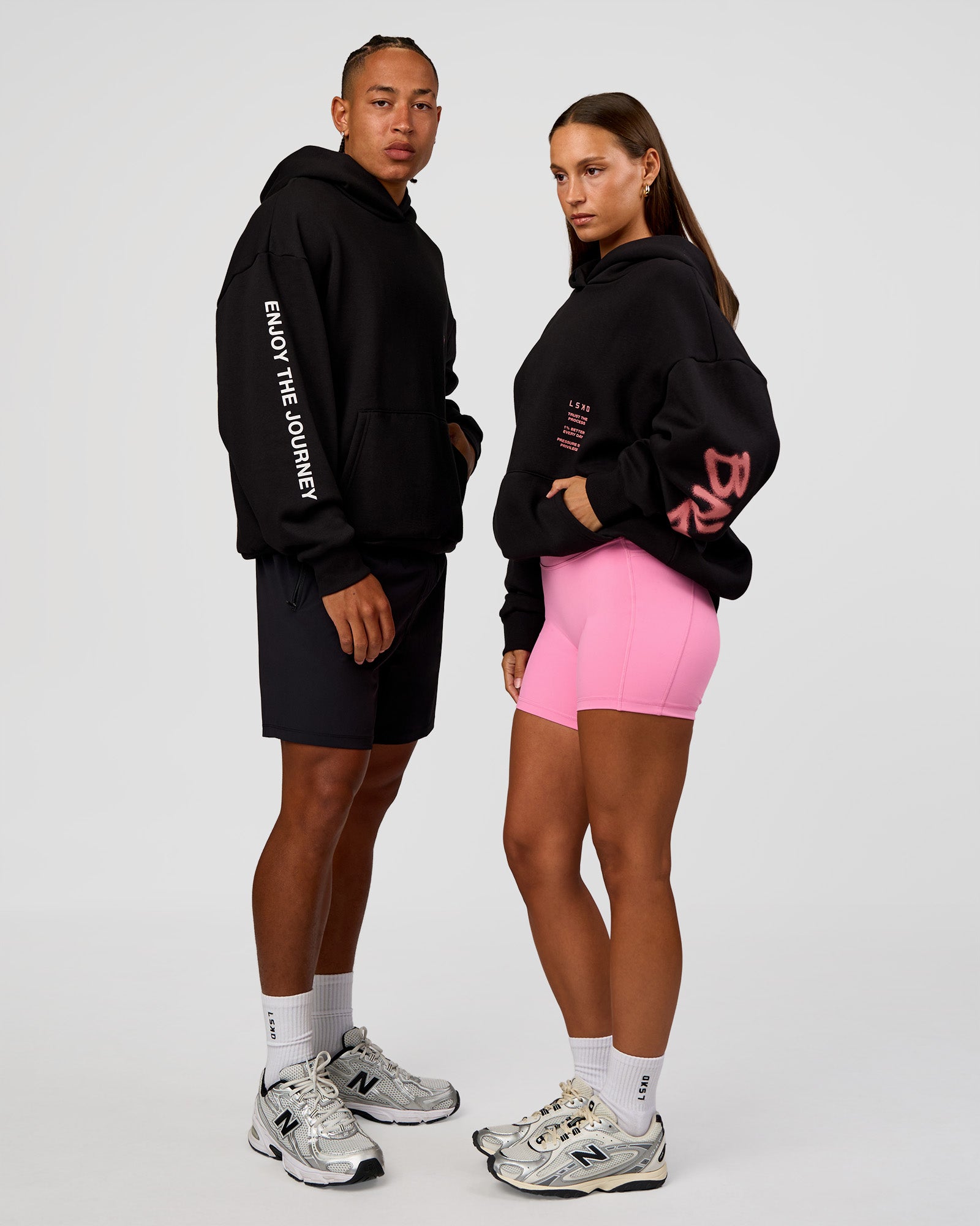 Duo wearing CFT BNE 26 Unisex Oversized Hoodie - Black-Candy Pink | Model:Brylee | Size:XS | Model:Malebo | Size:M