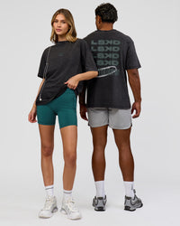 Duo wearing Everyday Elevation FLXCotton Oversized Tee - Black Washed-Carbon Green | Model:Leilani | Size:XS | Model:Xav | Size:L | Thumbnail Index: 1