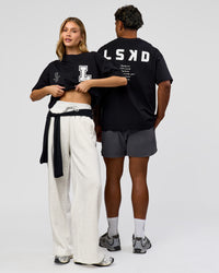 Duo wearing Hype Heavyweight Unisex Oversized Tee - Black-White | Model:Leilani | Size:XS | Model:Xavier | Size:L | Thumbnail Index: 3