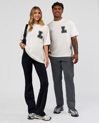 Duo wearing Hype Heavyweight Unisex Oversized Tee - Off White-Black | Model:Xavier | Size:L | Model:Brylee | Size:XS | Thumbnail Index: 1
